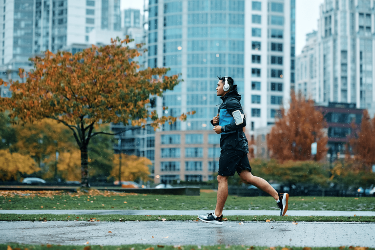 running outside in city with headphones