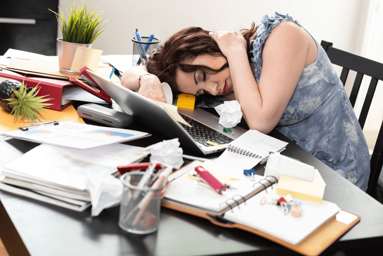 overworked business woman at messy desk