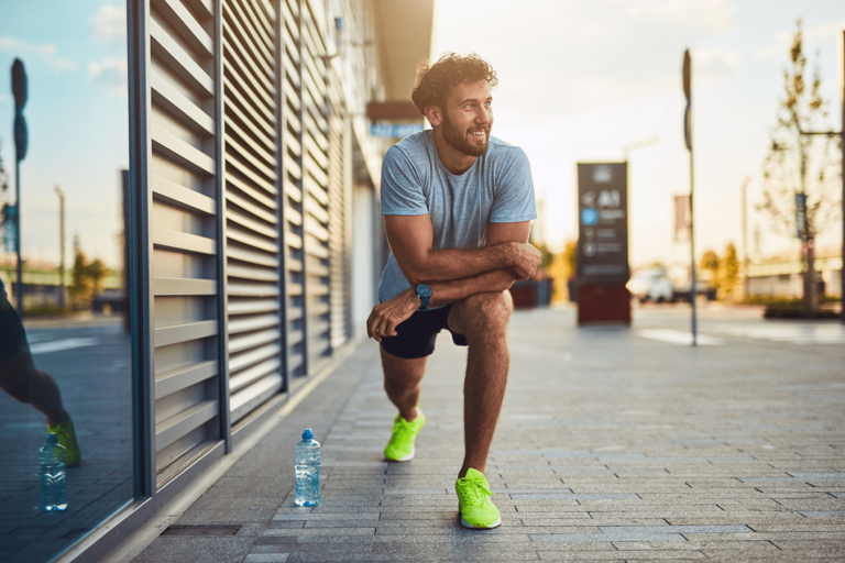 man stretching outside before workout