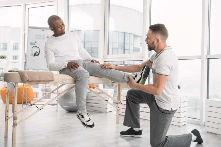 medical professional checking a mans knee for pain