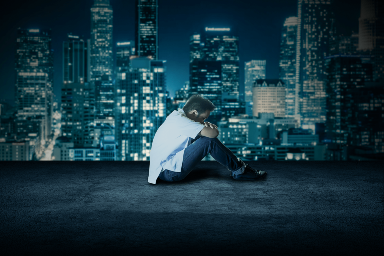 guy sitting outside on rooftop