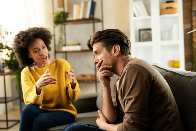 husband and wife having a serious conversation in living room