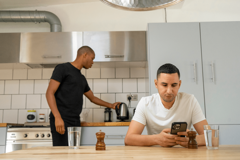 couple making coffee and checking their phone